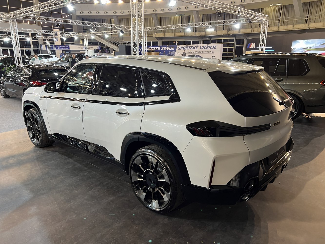 Large modern SUV with black-white two-tone and sporty rear design