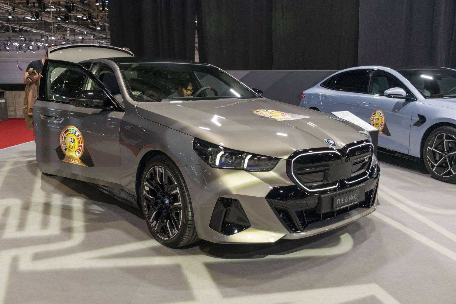 Front angled view of a sedan with open front door and Car of the Year finalist badge