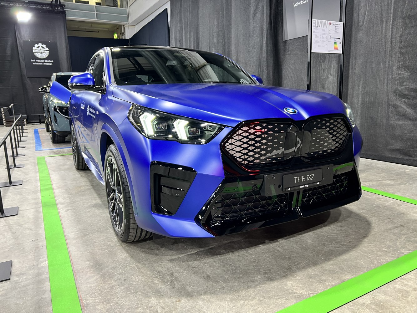 Electric SUV front with signature LED headlights and bold patterned grille