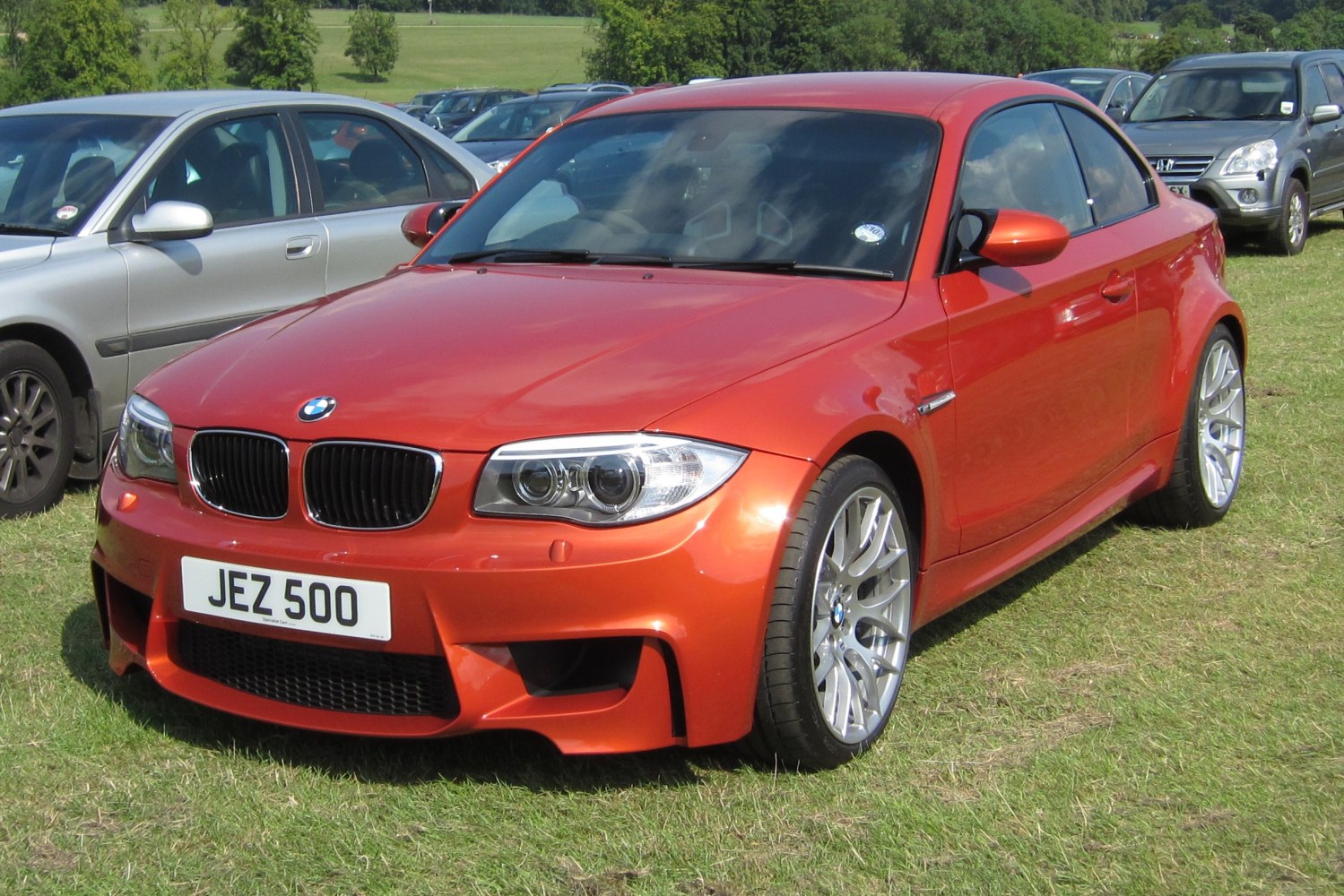 Front view of sporty coupe with wide fenders and aggressive air intakes