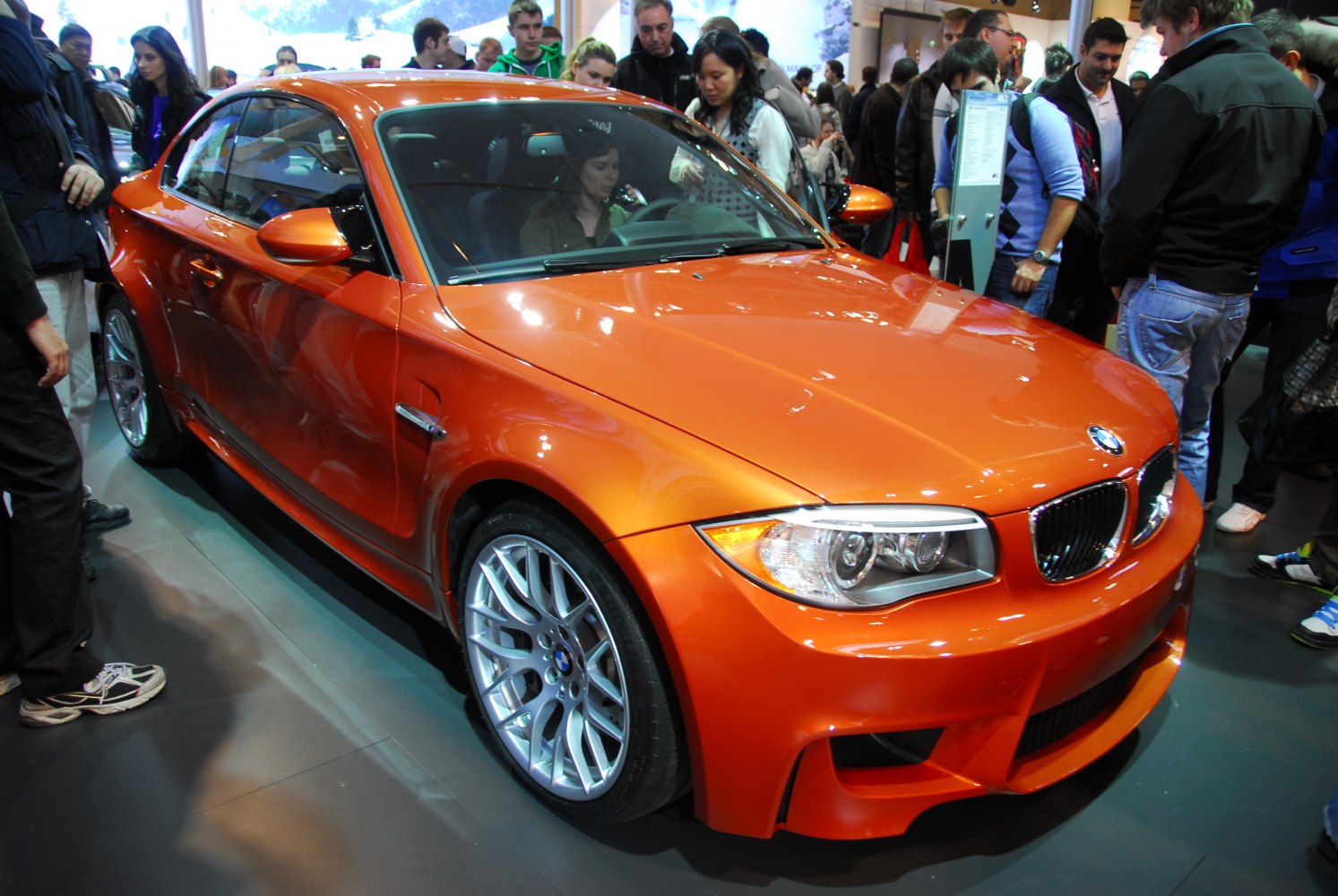 Orange coupe with aggressive front fascia and alloy wheels