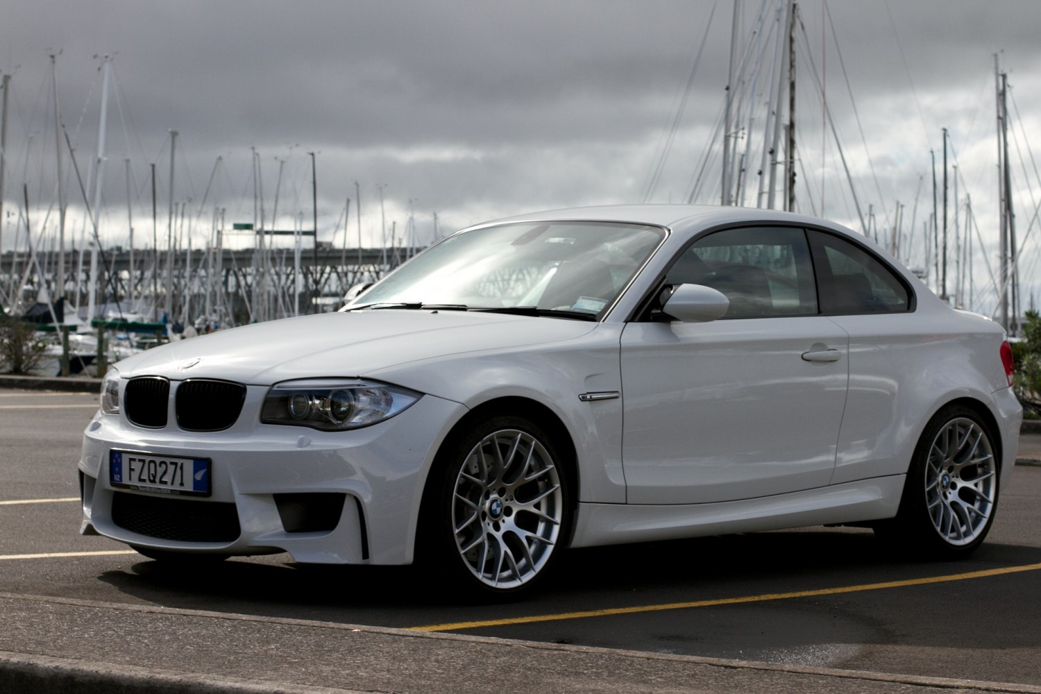 White sporty coupe with aggressive front bumper and alloy wheels