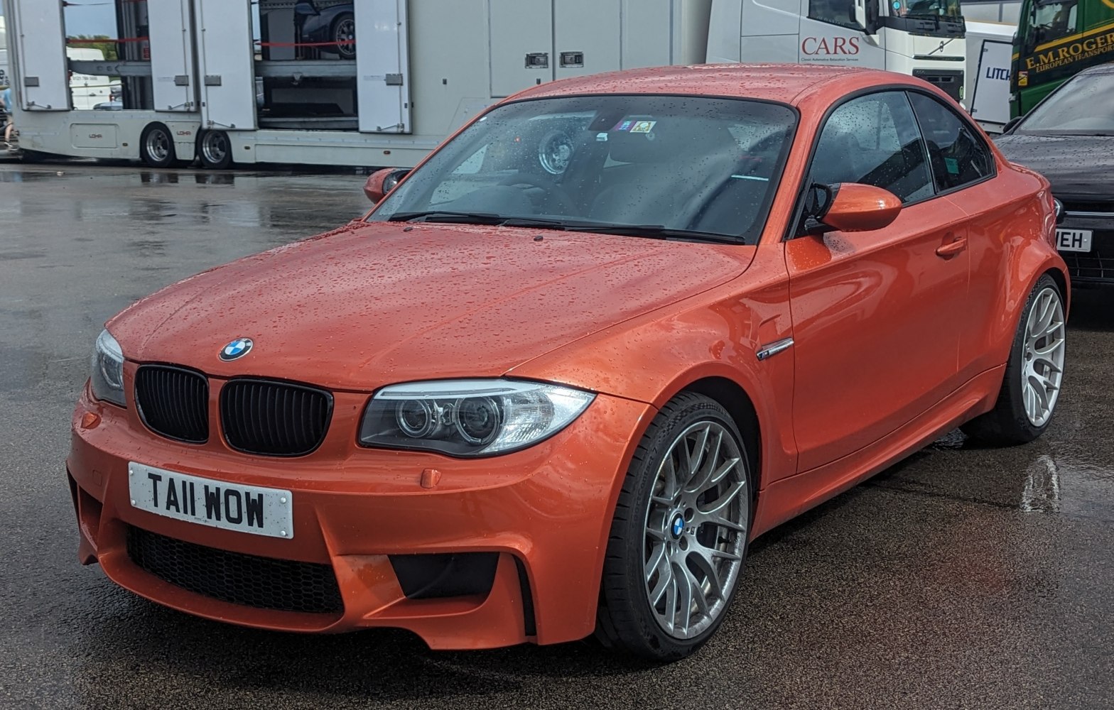 Aggressive front fascia and sporty wheels of an orange coupe
