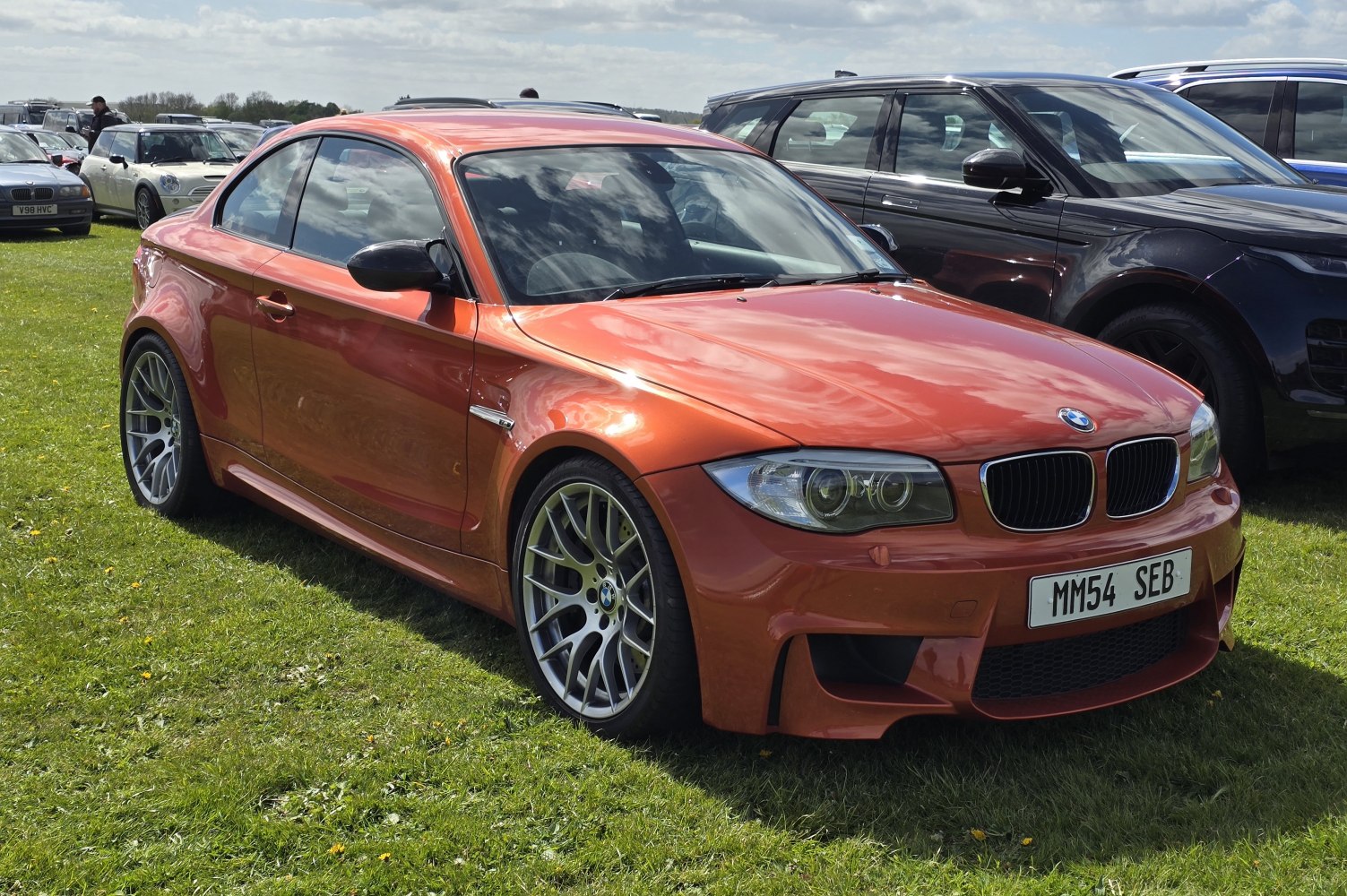 Orange sporty coupe with aggressive front and alloy wheels