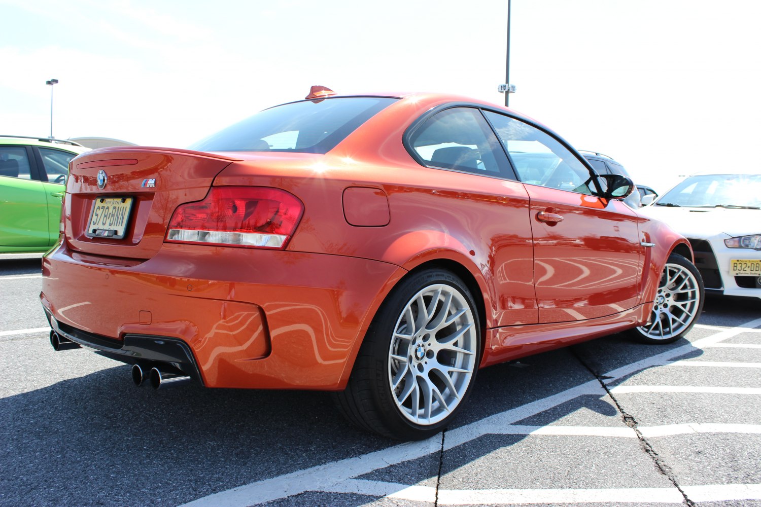 Rear and side view of a sporty coupe with quad exhaust and alloy wheels