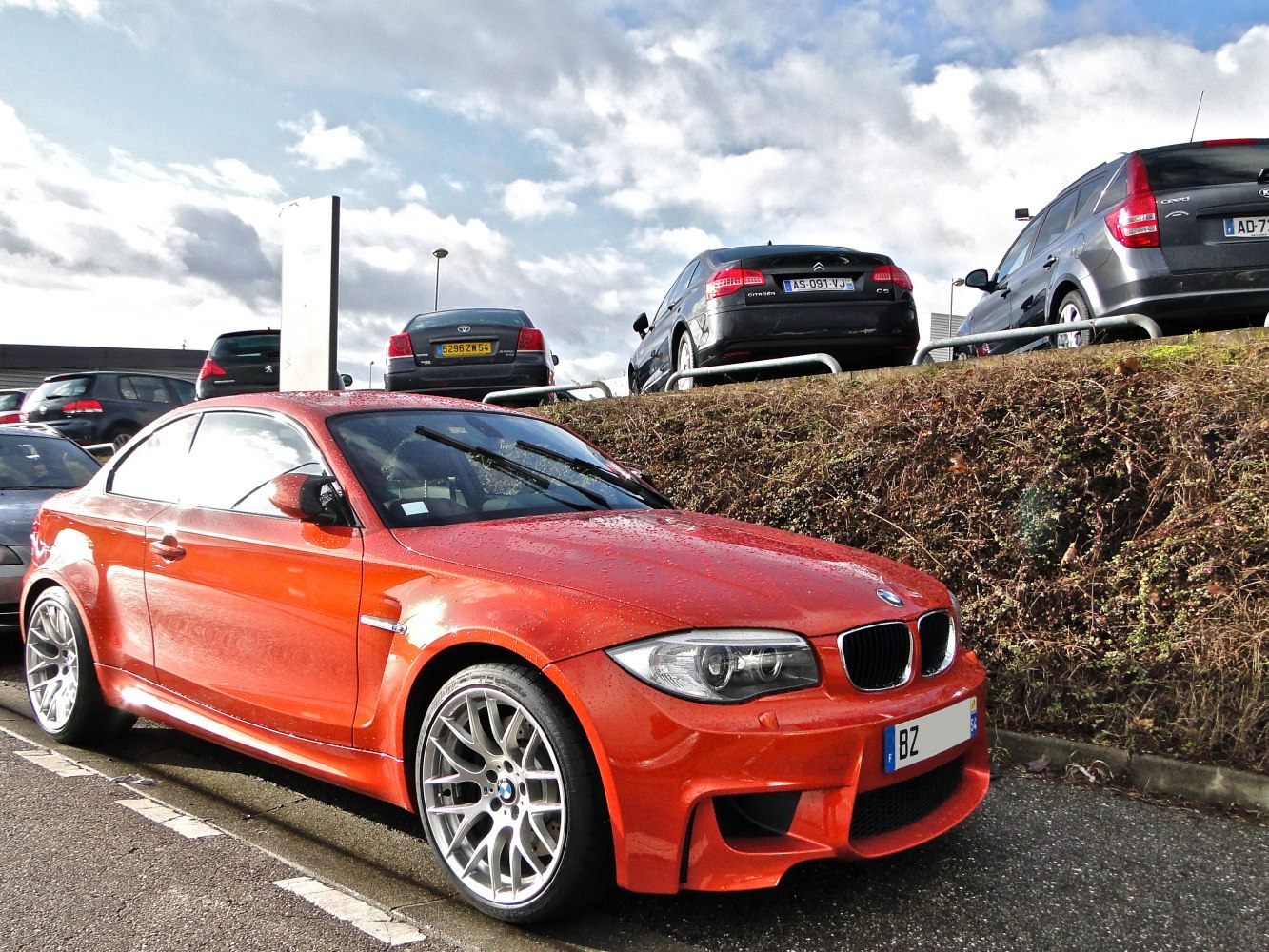 Aggressive widebody front-side view with sporty alloy wheels