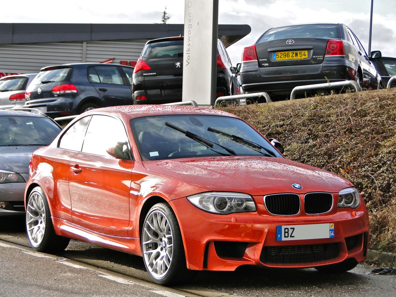 Front view of aggressive sports coupe with large alloy wheels and aerodynamic styling