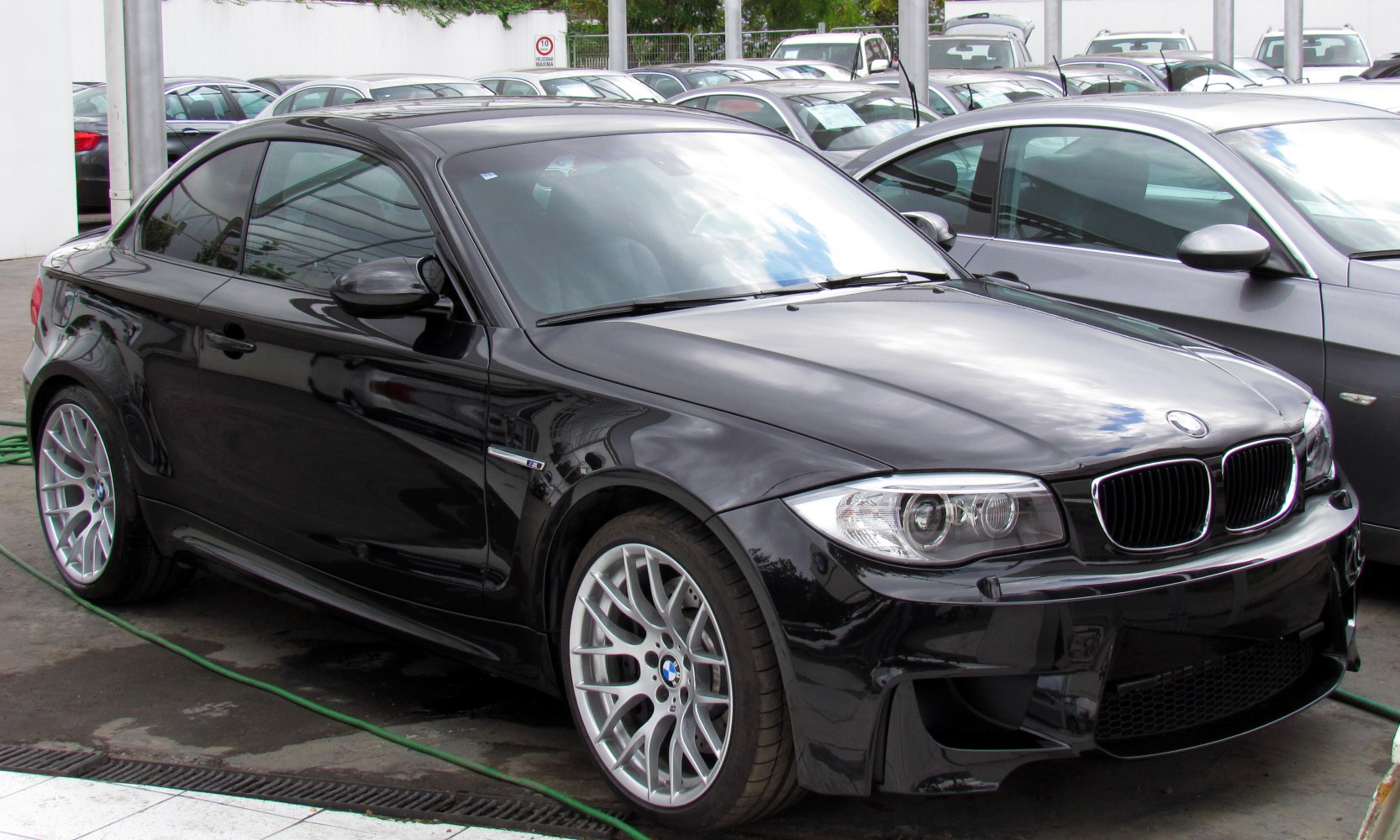 Aggressive front fascia and sporty side profile of black luxury coupe