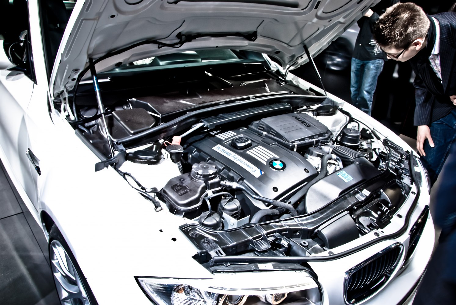Engine bay close-up showing BMW 1M Coupe's powertrain and components