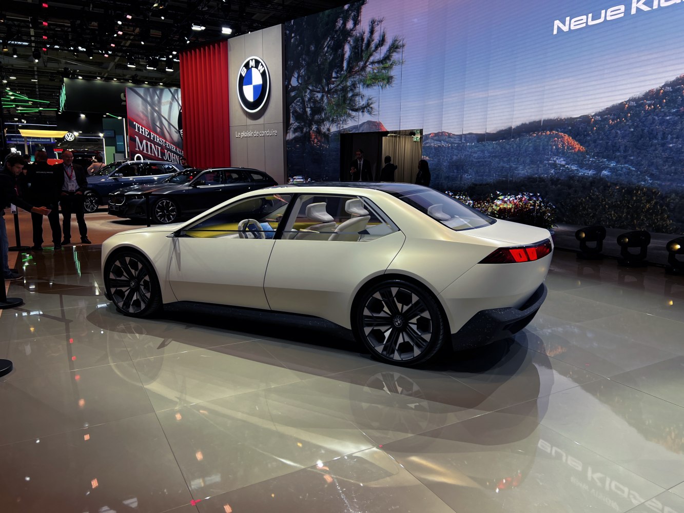 Electric sedan with futuristic rear and side design at auto show