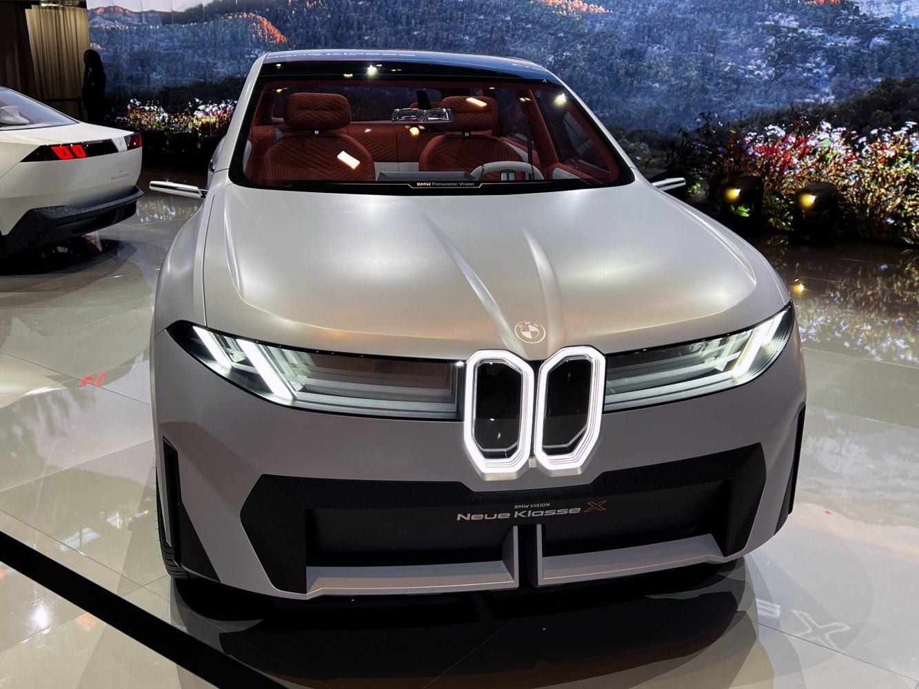 Futuristic car front with LED headlights and large unique grille design