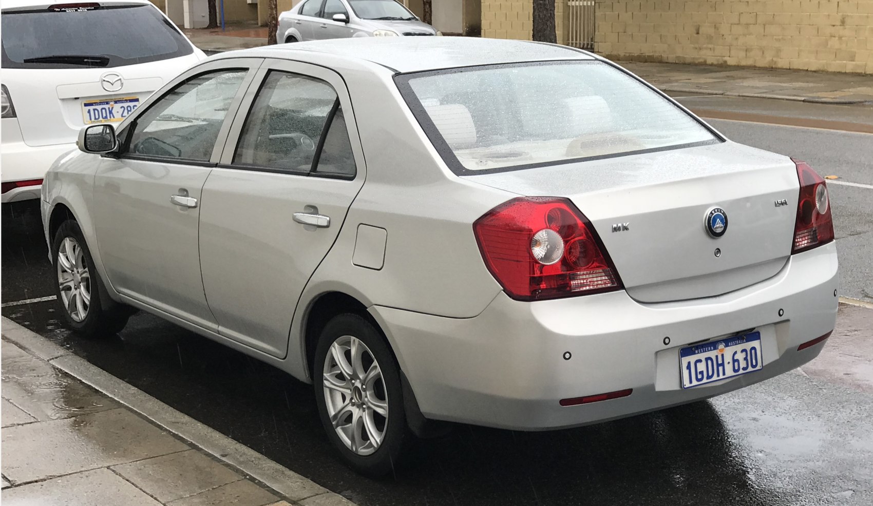 Rear view of sedan with prominent taillights and trunk features