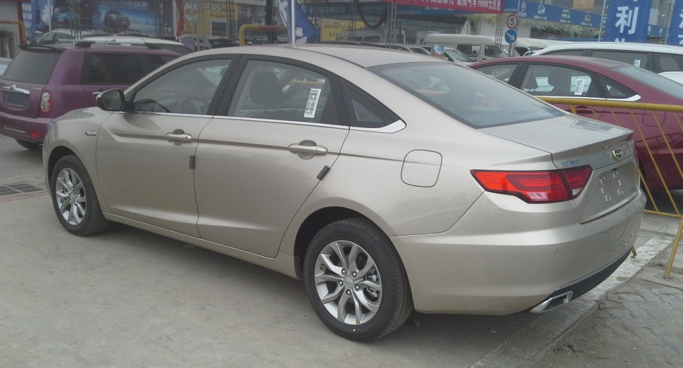 Rear side view of a 2016 sedan with alloy wheels and sharp taillights