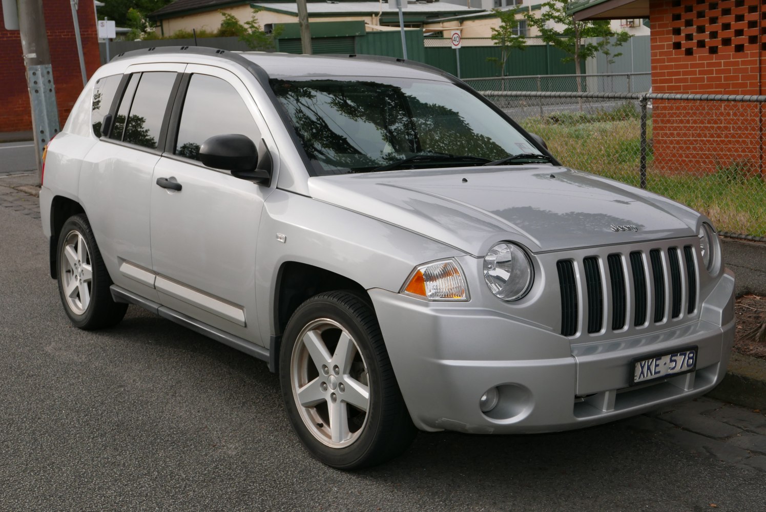 Silver SUV with vertical slat grille and round headlights