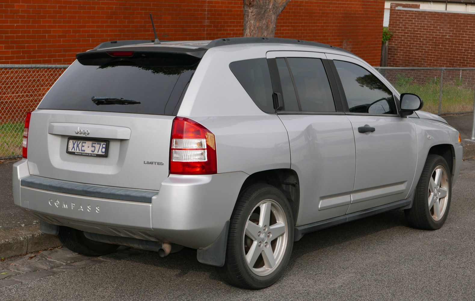 Rear and side view of a silver SUV with tinted windows and alloy wheels