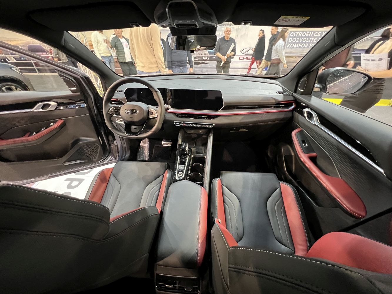 Digital dashboard and sporty red-black seats in car interior