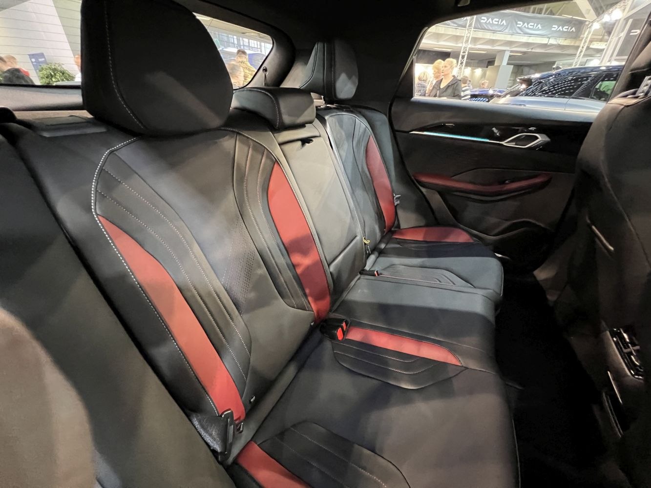 Rear seat interior with black leather and red accents