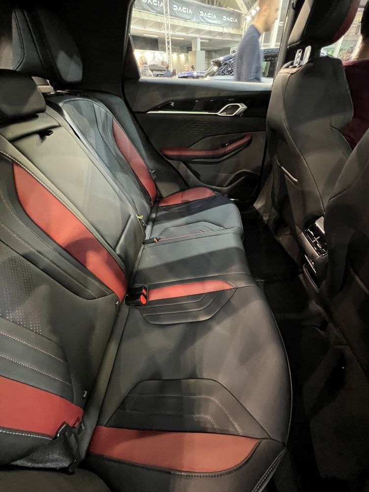 Rear seat with black and red upholstery and detailed stitching