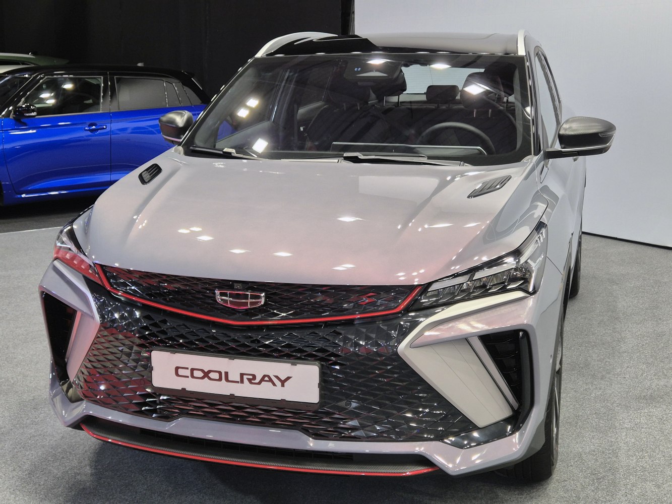 Front view featuring diamond-pattern grille and sleek angular headlights.