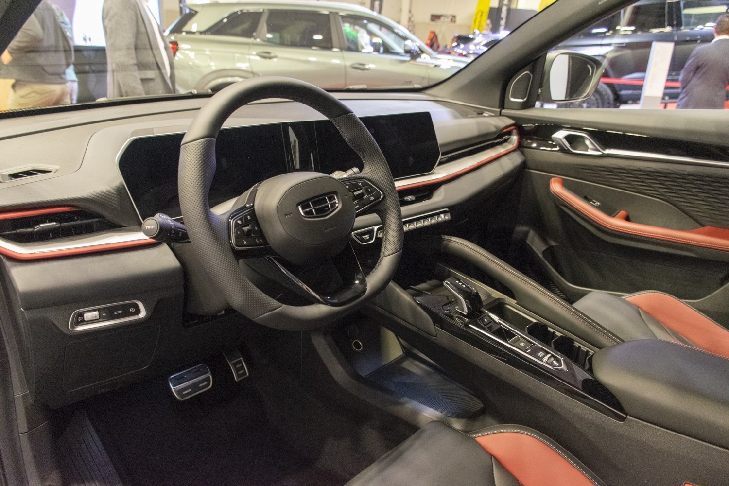 Perforated steering wheel with dual digital displays and red accent interior trim