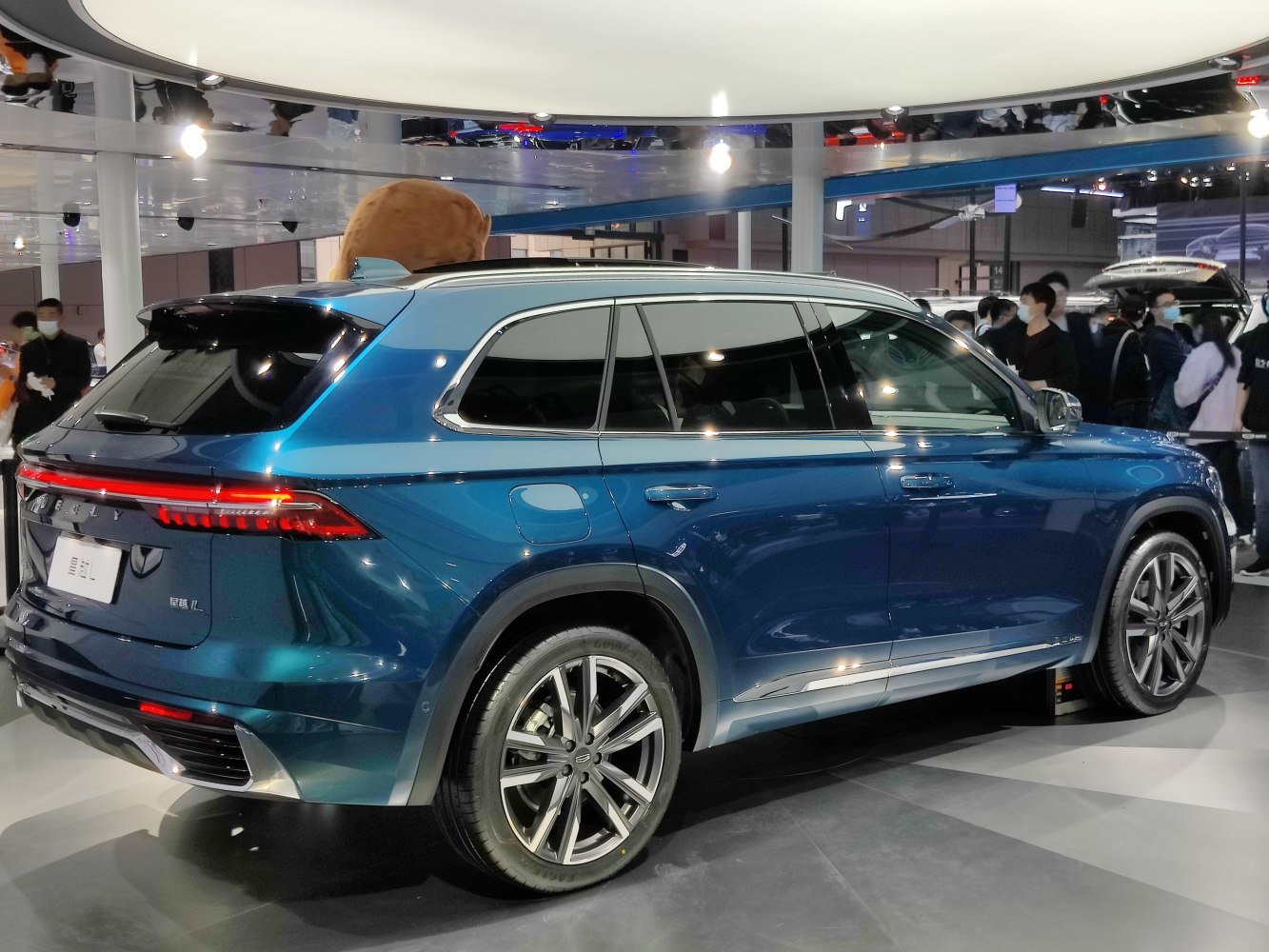 Rear side view of blue SUV with alloy wheels and sleek design