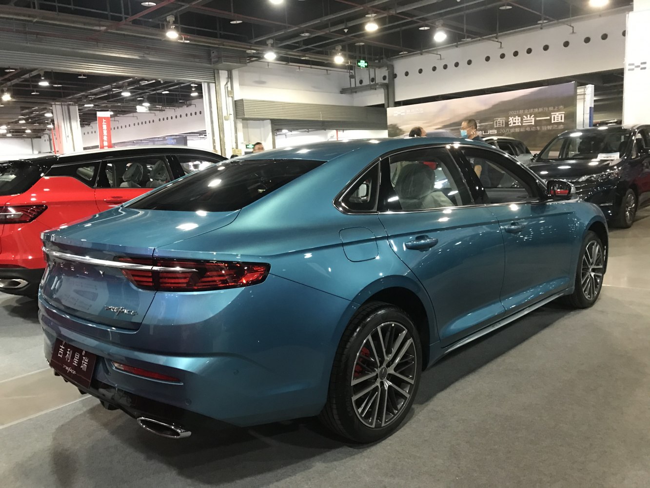 Rear and side view of blue sedan with LED taillights and alloy wheels