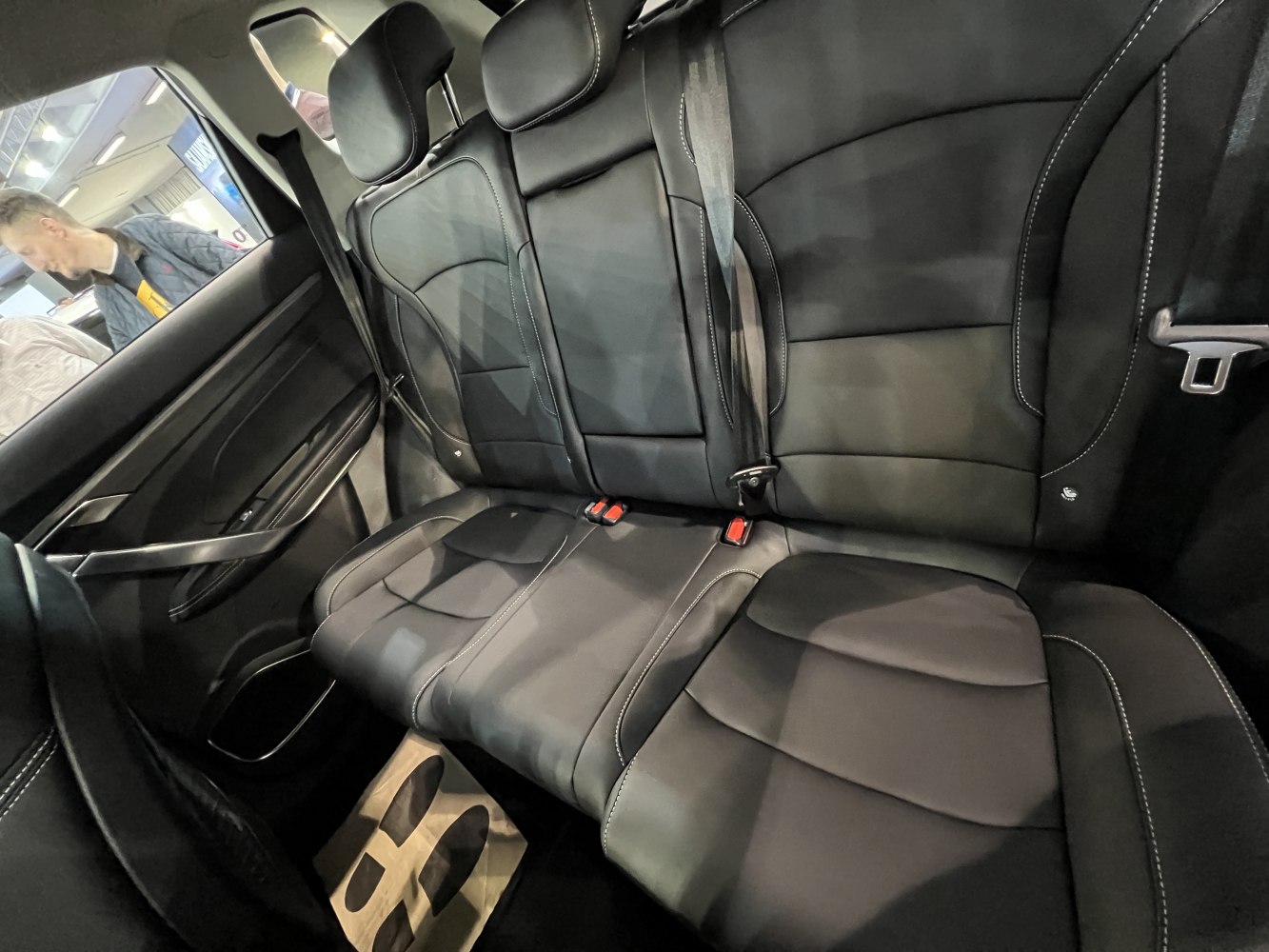 Black leather rear seats with seatbelts and detailed stitching