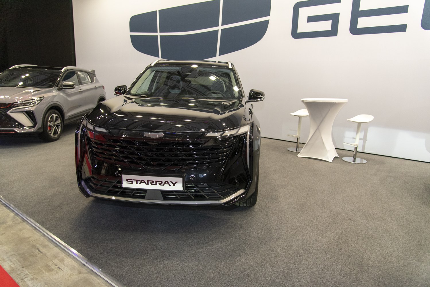 Angular grille with integrated LED headlights on an SUV front view.