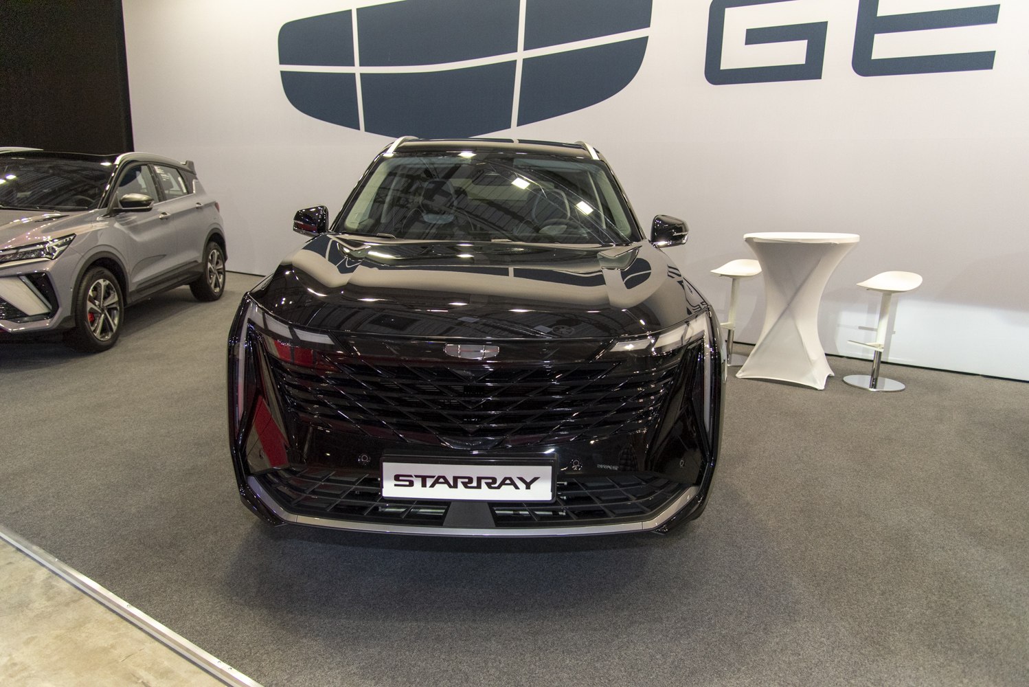 Front view with sleek black grille and sharp LED headlights.