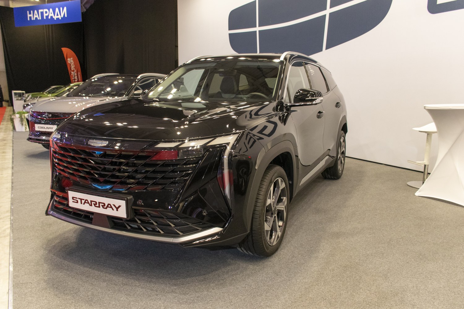 Front view of a sleek black SUV with a distinctive grille and LED headlights