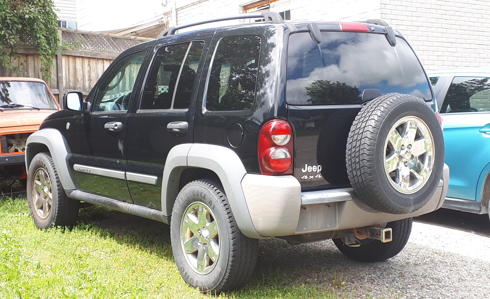 Rear side view showing mounted spare tire and 4x4 badge