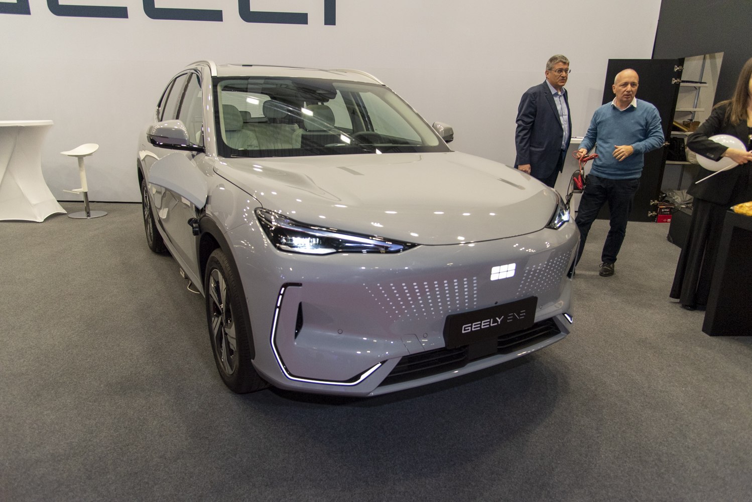 Front view of modern SUV with LED headlights and illuminated grille