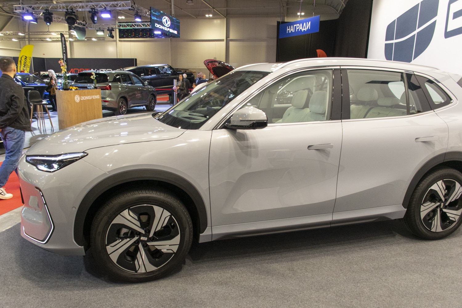 Side profile of modern electric SUV with LED headlights and aerodynamic wheels