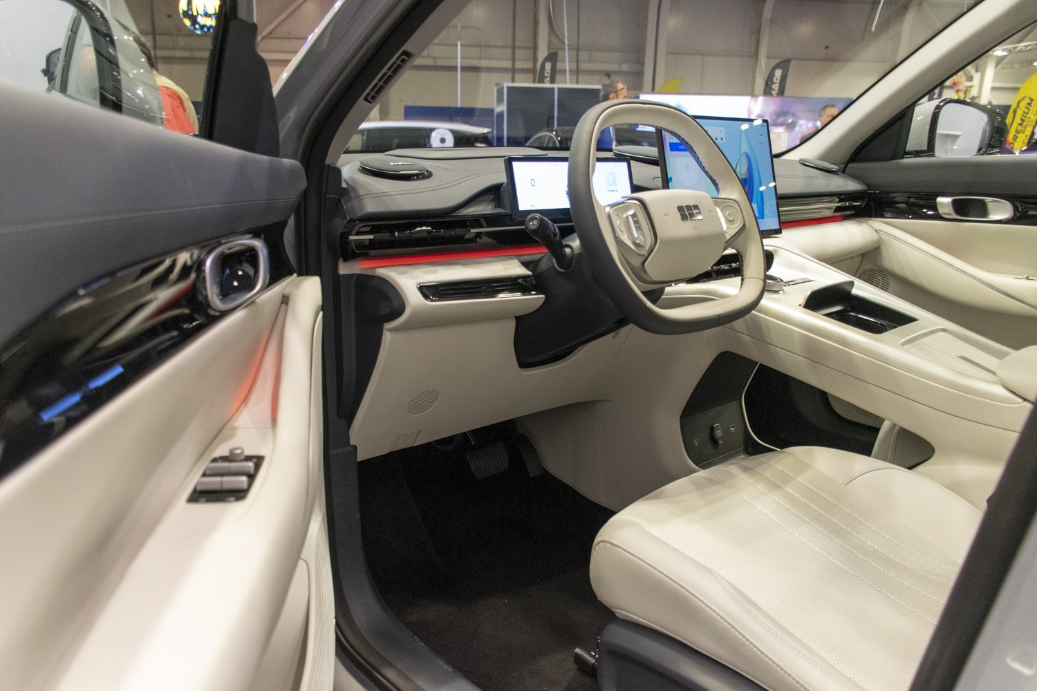 Futuristic car interior with digital displays and unique steering wheel