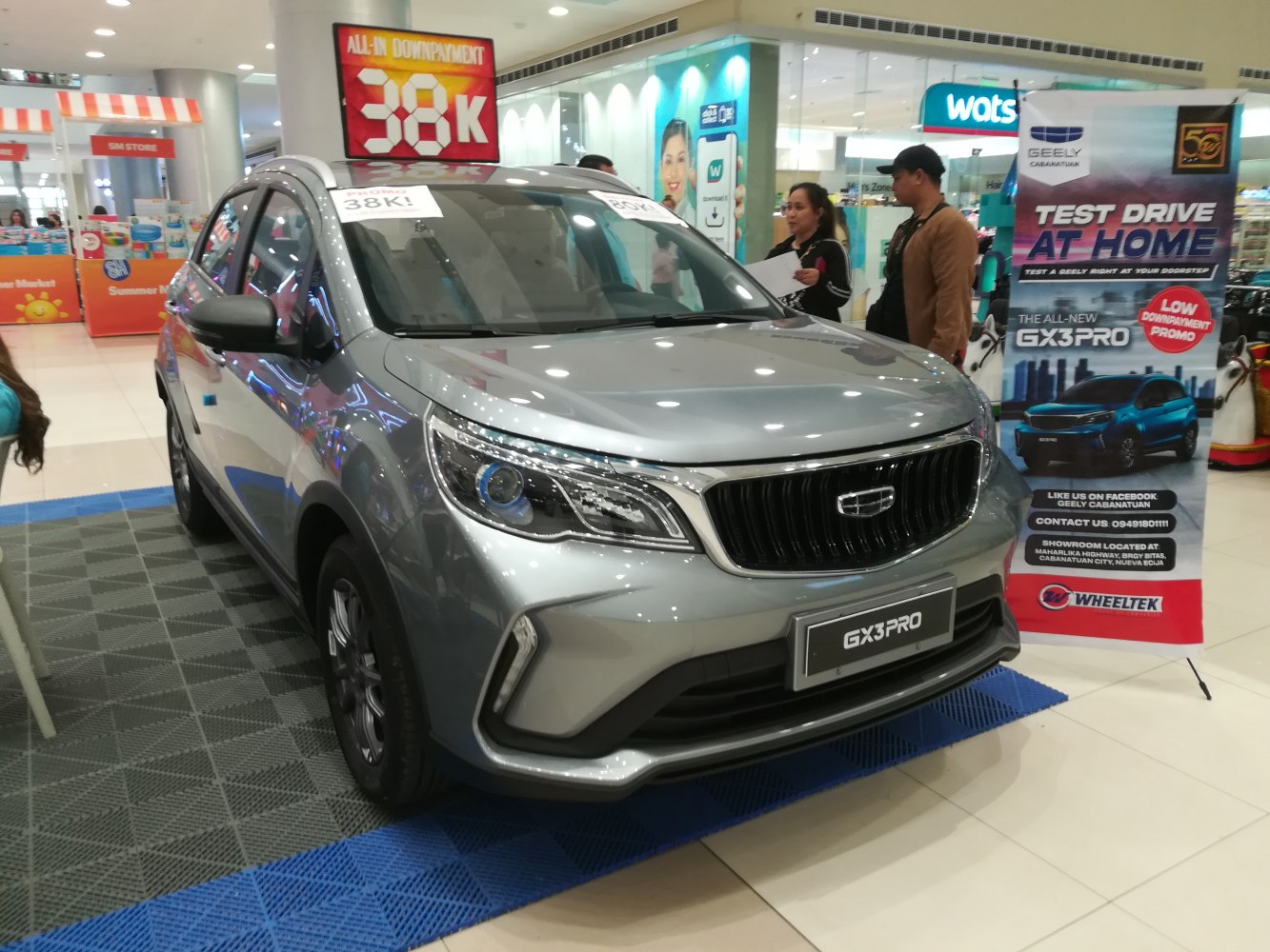 Front grille and LED headlights of a compact hatchback on mall display