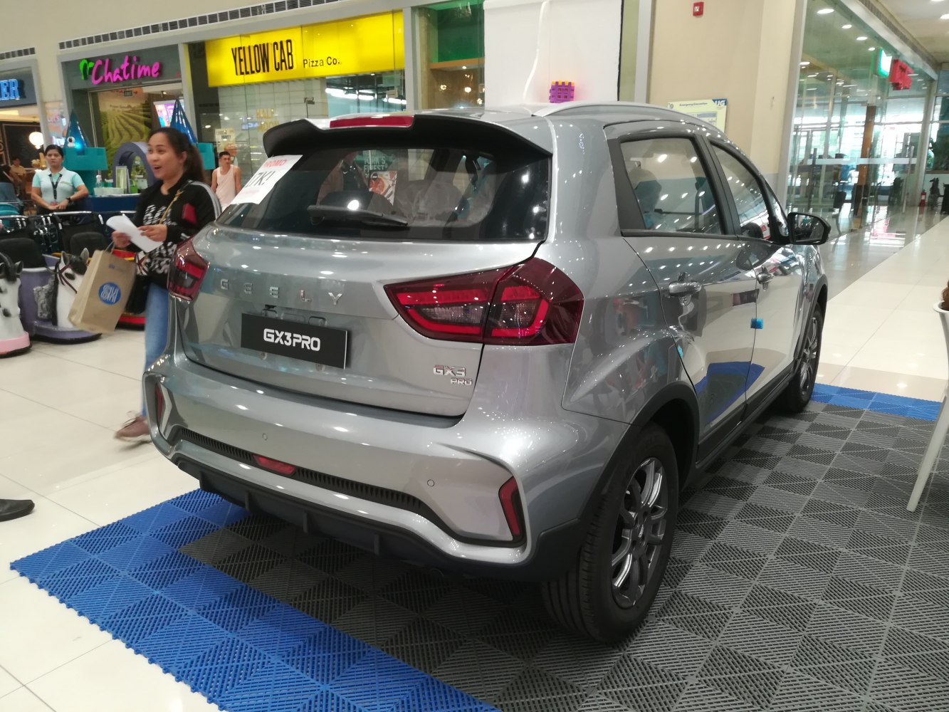 Rear view of compact SUV with modern tail lights and aerodynamic spoiler