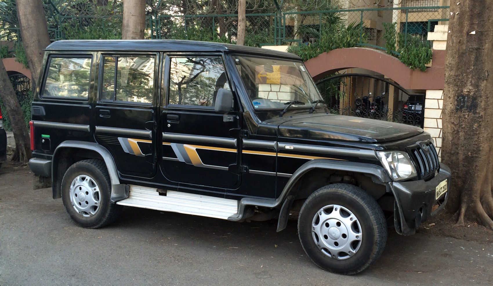 Side view of black SUV with fender flares and step board