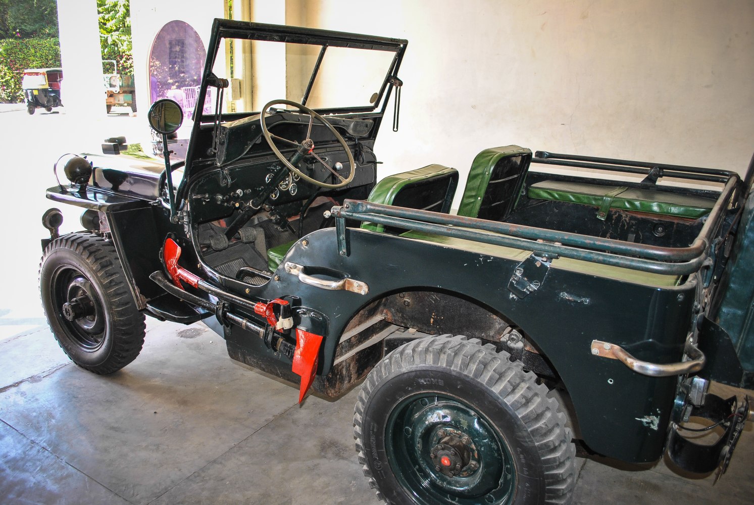 Open-top vintage off-road vehicle with rugged tires and classic interior