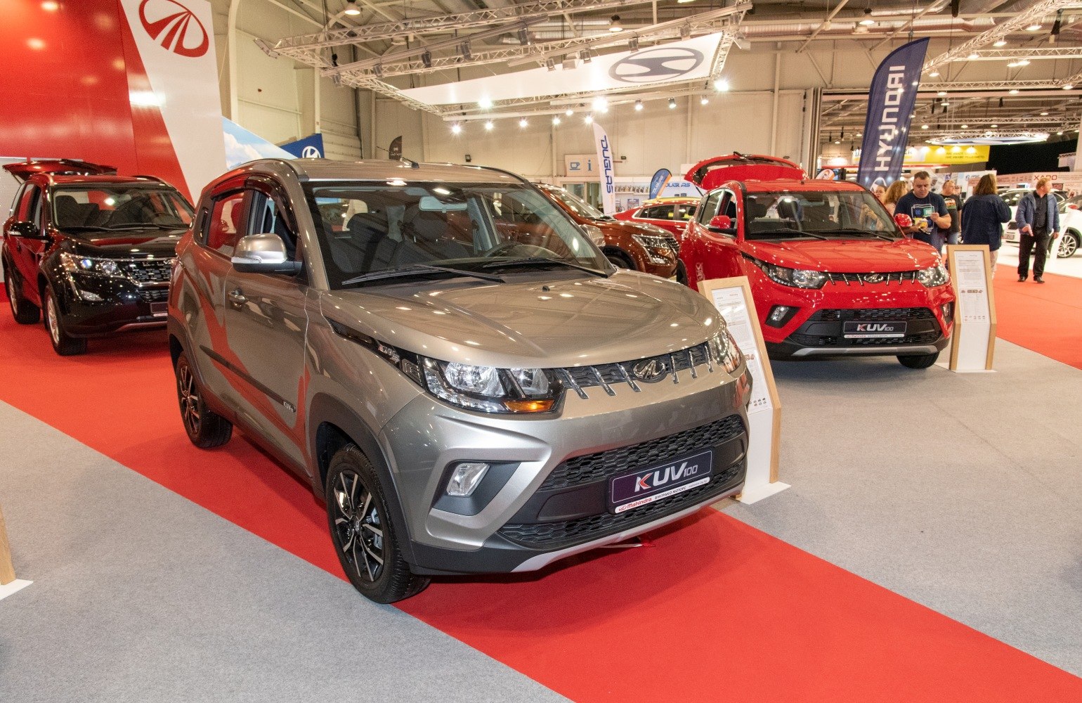 Front and side exterior view of a compact SUV at an auto exhibition