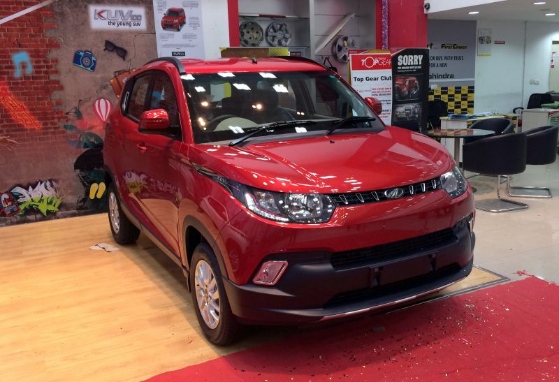 Red compact SUV front view with bold grille and sleek headlights