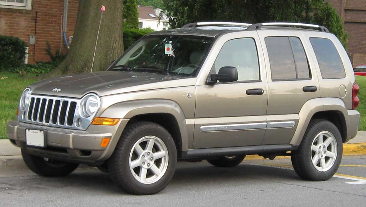 Round headlights, chrome grille, raised SUV body with alloy wheels