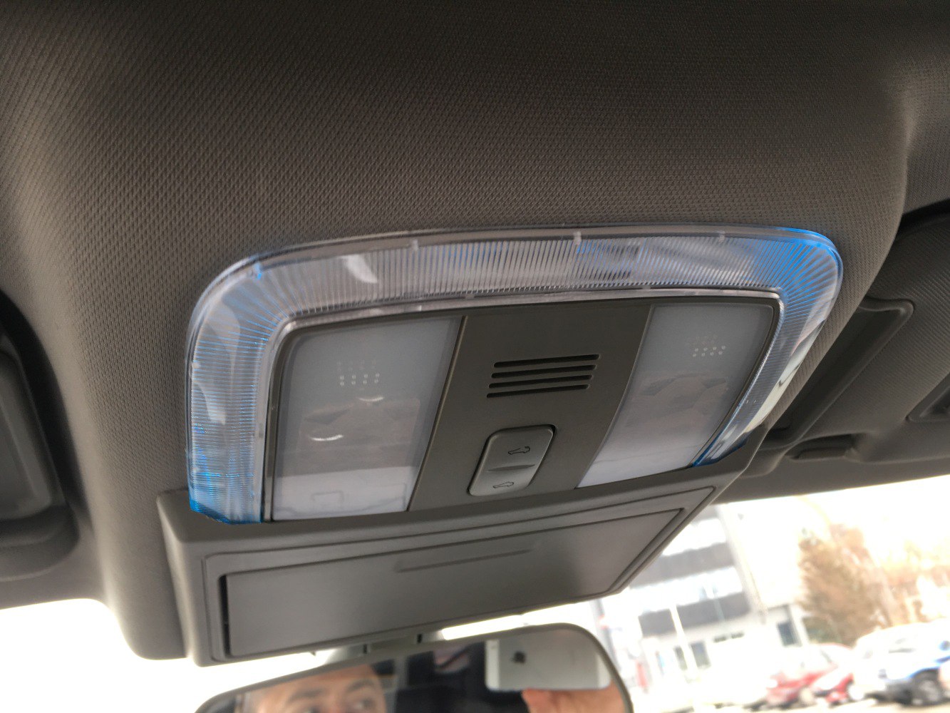 Interior overhead console light with control buttons and translucent cover
