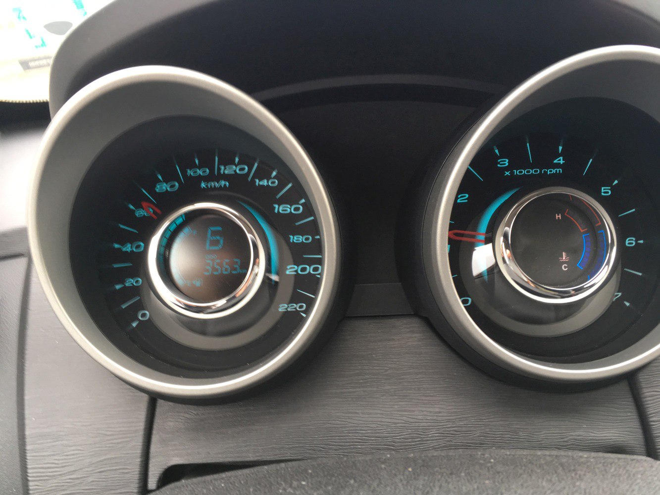 Car instrument cluster with speedometer and tachometer gauges