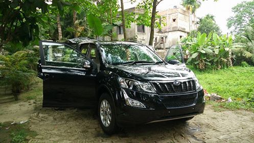Front view of black SUV with front and rear driver's side doors open