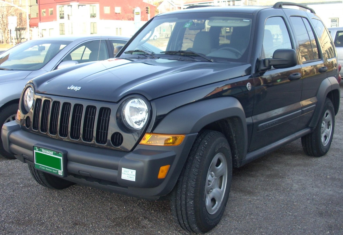 Black SUV with seven-slot grille and round headlights