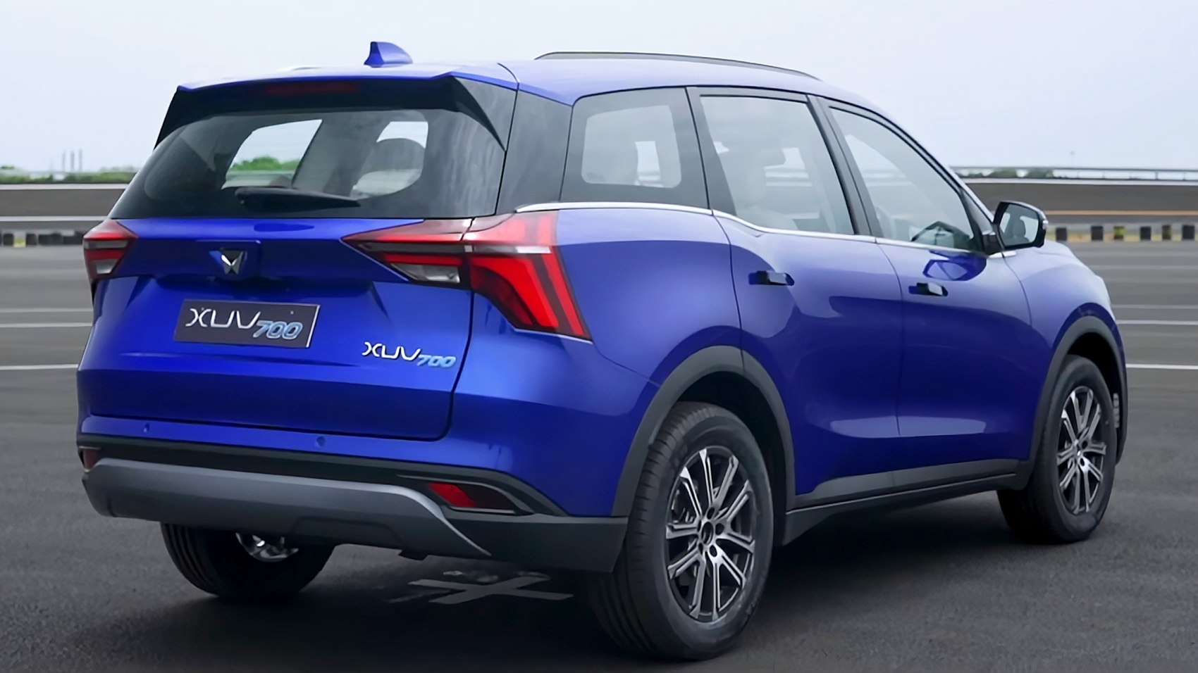 Rear and side view of a blue SUV with modern taillights and alloy wheels