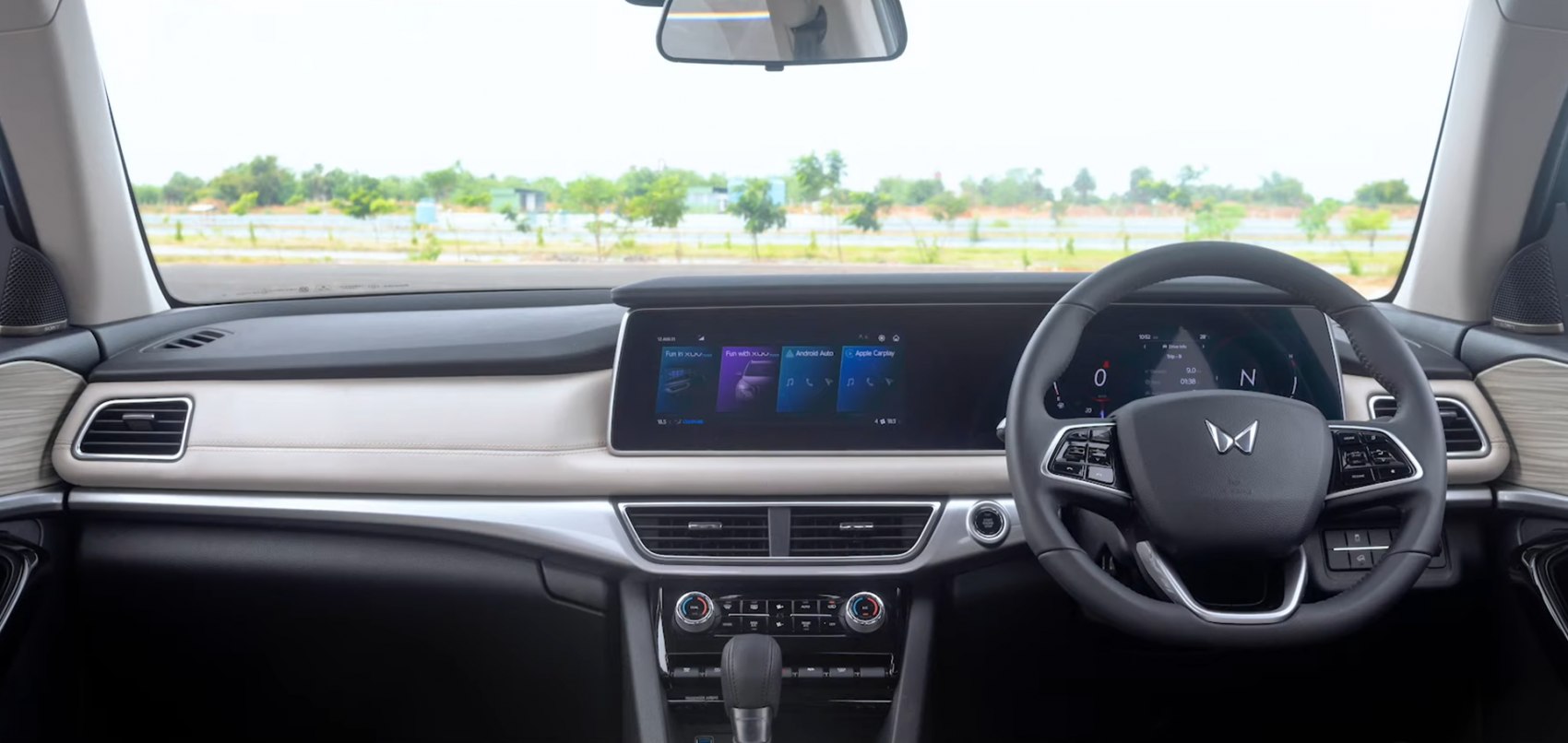 Dual digital displays and multifunction steering wheel in modern car interior