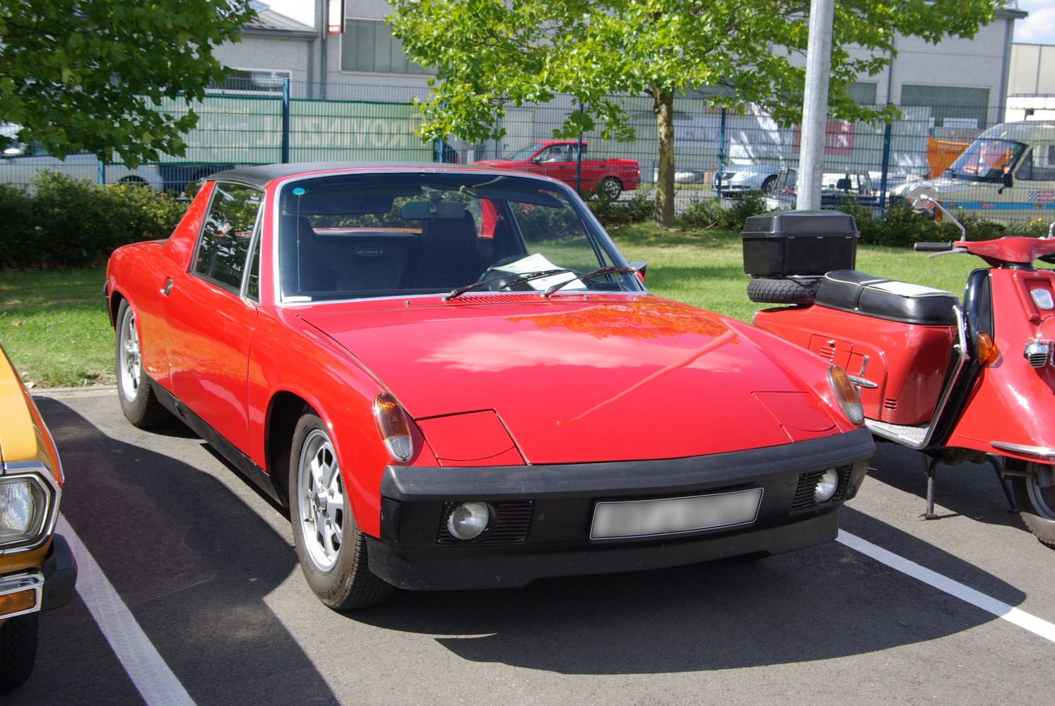 Red sports coupe with pop-up headlights and sleek body lines