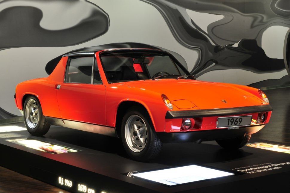 Low-profile sports coupe with bright orange body and unique 1960s design