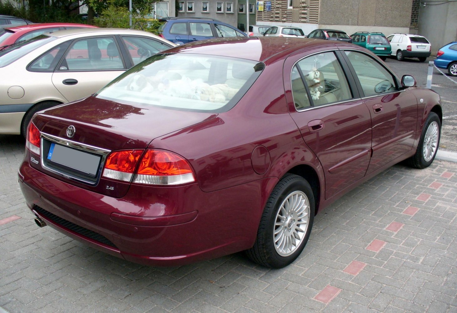 Rear and side view of a sedan with alloy wheels and distinctive taillights